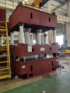 A large machine in a factory with many parts